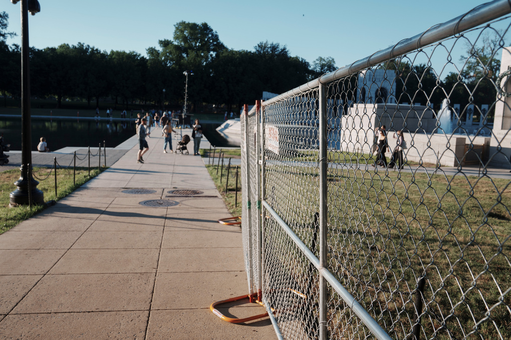 Fencing that will secure an area around where fireworks for the Fourth of July will be launched is seen near the Lincoln Memorial Reflecting Pool and the World War II Memorial Tuesday, June 23, 2026, in Washington. (AP Photo/Jon Elswick)