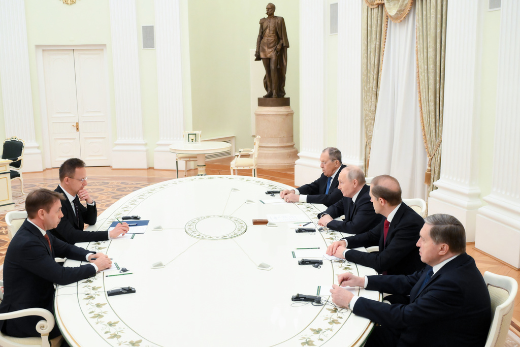 Russian President Vladimir Putin, third right, speaks with Hungarian Foreign Minister Peter Szijjarto, second left, during their meeting at the Senate Palace of the Kremlin in Moscow, Wednesday, March 4, 2026. (Grigory Sysoyev, Sputnik, Kremlin Pool Photo via AP)