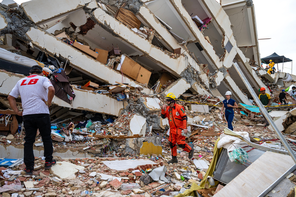 Volunteers and a Mexican rescuer help to find survivors in a collapsed building in Caraballeda, La Guaira state, Venezuela, on June 30, 2026, following the June 24 twin earthquakes. (Miguel Medina/Pool Photo via AP)