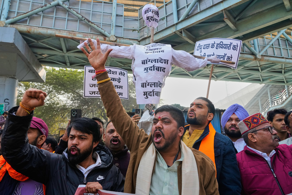 Activists of Vishwa Hindu Parishad, a prominent right-wing Hindu nationalist organization, shout slogans during a protest near Bangladesh High Commission accusing Bangladeshi groups of wrongly targeting Indians, in New Delhi, India, Tuesday, Dec.23, 2025. (AP Photo/Manish Swarup)