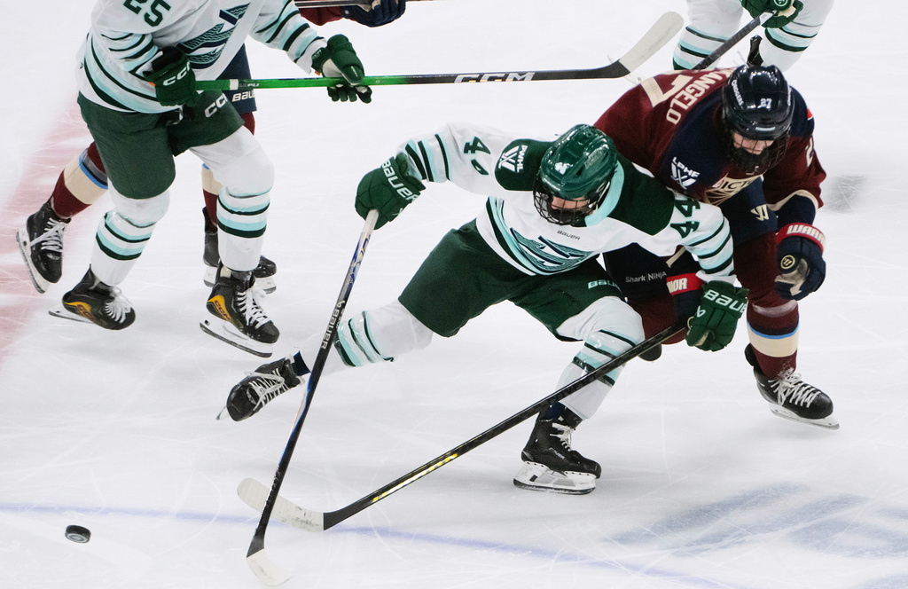 Boston Fleet's Jill Saulnier (44) fights off Montreal Victoire's Shiann Darkangelo (27) to keep possession of the puck during first-period PWHL hockey game action against the Boston Fleet in Laval, Quebec, Sunday March 15, 2026. (Peter McCabe/The Canadian Press via AP)