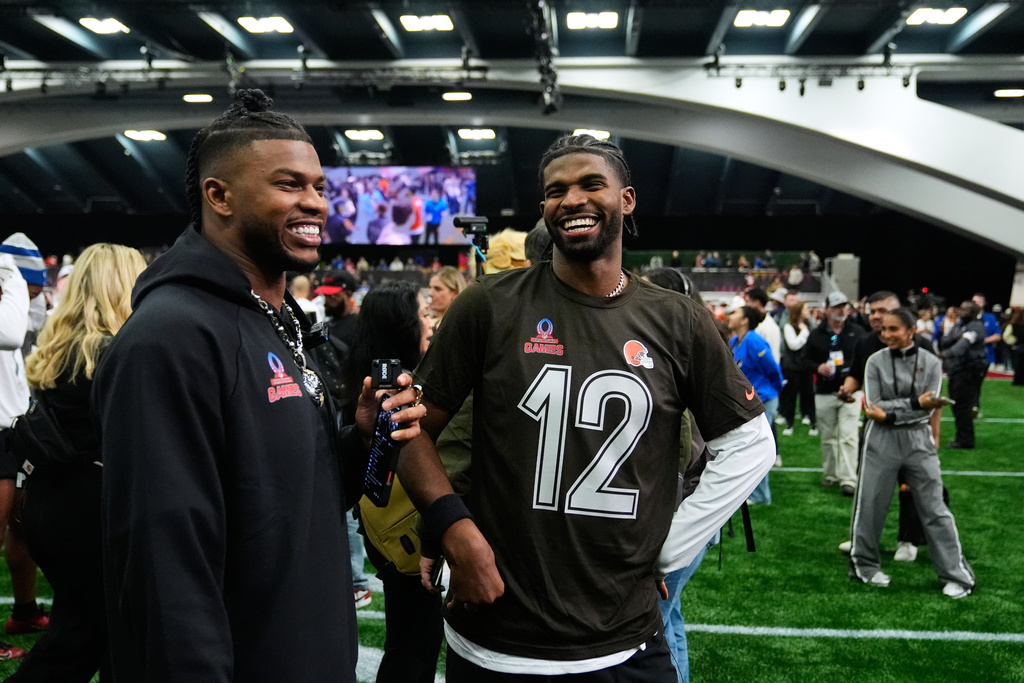 AFC quarterback Shedeur Sanders (12), of the Cleveland Browns, speaks with his brother Shilo Sanders, left, after the NFL Pro Bowl football game against the NFC, Tuesday, Feb. 3, 2026, in San Francisco. (AP Photo/Godofredo A. Vásquez)