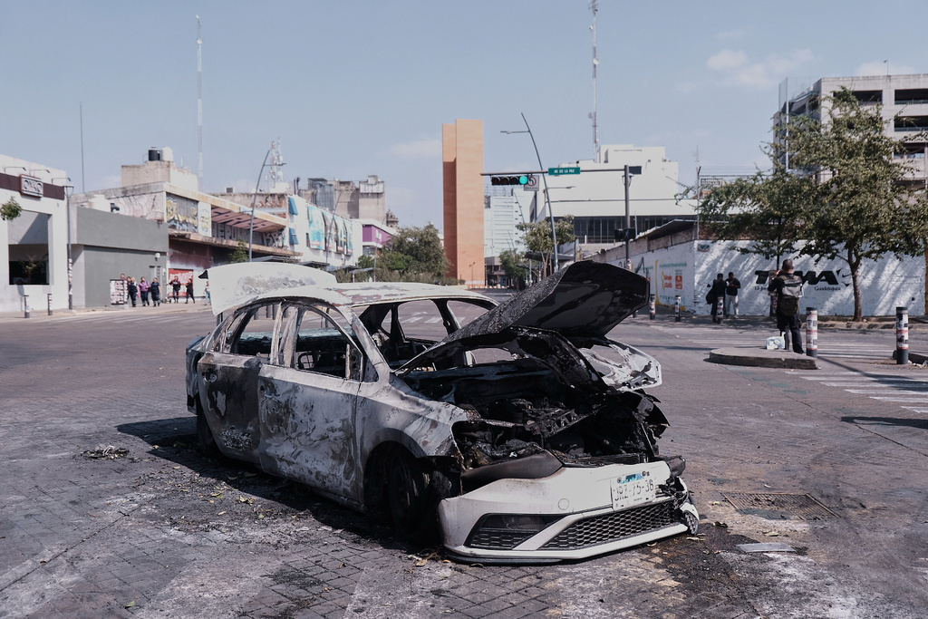 A vehicle sits charred after being set on fire, on a road in Guadalajara, Jalisco state, Mexico, Sunday, Feb. 22, 2026, after the death of the leader of the Jalisco New Generation Cartel, Nemesio Rubén Oseguera Cervantes, known as"El Mencho." (AP Photo/Alejandra Leyva)