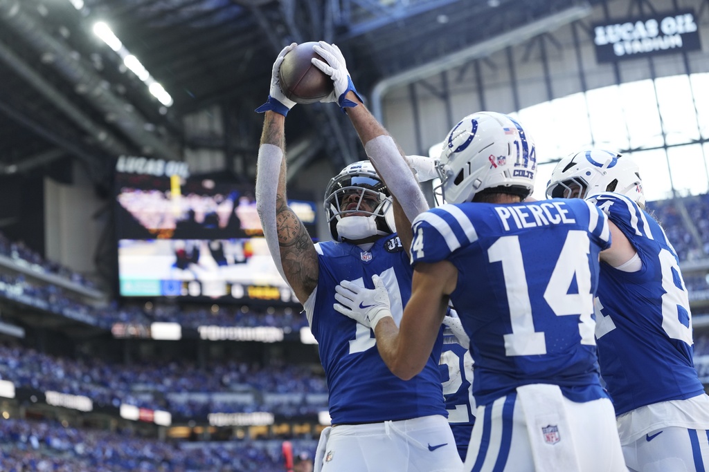 Indianapolis Colts wide receiver Michael Pittman Jr. (11) celebrates scoring a touchdown with teammates during the first half of an NFL football game against the Miami Dolphins on Sunday, Sept. 7, 2025, in Indianapolis. (AP Photo/AJ Mast)