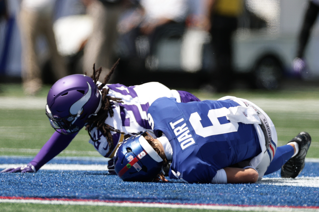 New York Giants quarterback Jaxson Dart (6) is sacked by Minnesota Vikings safety Jay Ward (24) during the first half of a preseason NFL football game Saturday, Aug. 15, 2026, in East Rutherford, N.J. (AP Photo/Adam Hunger)