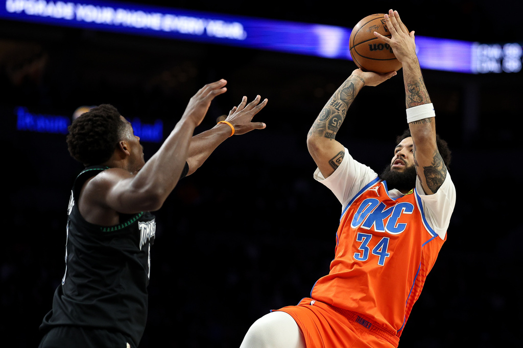 Oklahoma City Thunder guard Kenrich Williams, right, shoots over Minnesota Timberwolves guard Anthony Edwards (5) during the first half of an NBA basketball game, Thursday, Jan. 29, 2026, in Minneapolis. (AP Photo/Matt Krohn)