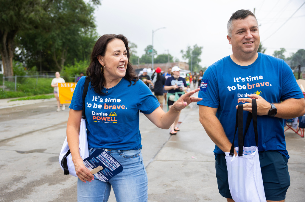 Denise Powell, left, the Democratic candidate for the House of Representatives in Nebraska's second congressional district, and her husband, Hobson, walk with the Nebraska Democratic Party in a Juneteenth Parade in Omaha, Neb., Saturday, Aug. 15, 2026. (AP Photo/Rebecca S. Gratz)