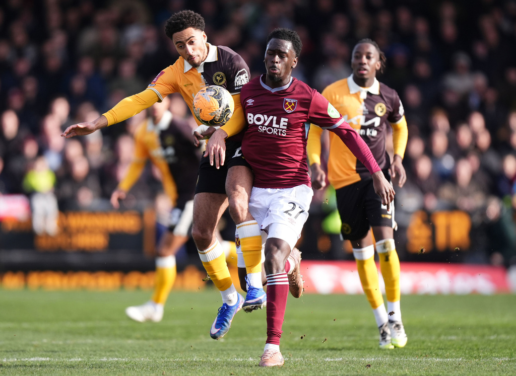 Burton Albion's Kain Adom, left, and West Ham United's Soungoutou Magassa in action during the English FA Cup fourth round soccer match between Burton Albion and West Ham United in Burton upon Trent, England, Saturday Feb. 14, 2026. (Mike Egerton/PA via AP)