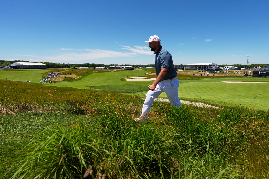Jon Rahm, of Spain, walks to green on the 18th hole during a practice round for the U.S. Open golf tournament at Shinnecock Hills Golf Club in Southampton, N.Y., Monday, June 15, 2026.(AP Photo/David J. Phillip)