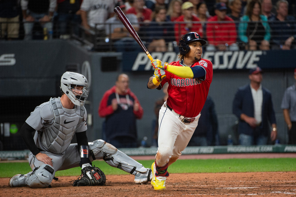 Cleveland Guardians' Jose Ramirez, right, watches his two-run RBI double off Detroit Tigers relief pitcher Will Vest as catcher Dillon Dingler, left, looks on during the seventh inning of a baseball game, Wednesday, Sept. 24, 2025, in Cleveland. (AP Photo/Phil Long)