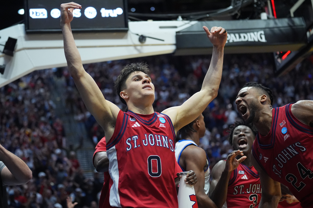 St. John's guard Dylan Darling (0) celebrates after St. John's defeated Kansas in the second round of the NCAA college basketball tournament Sunday, March 22, 2026, in San Diego. (AP Photo/Marcio Jose Sanchez)