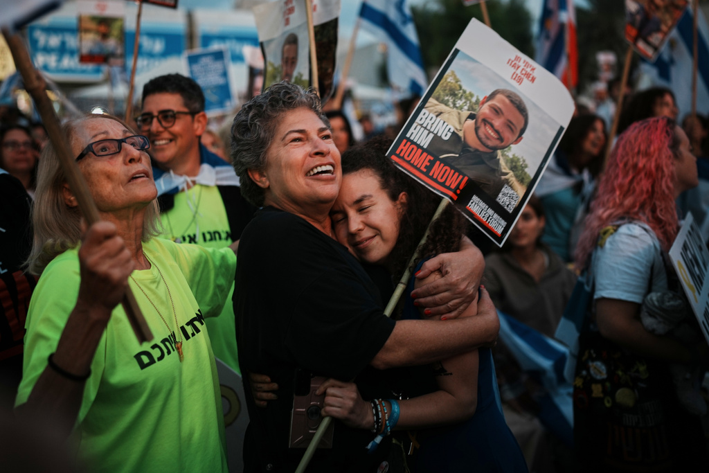 People gather prior to the release of Israeli hostages held in Gaza, at a plaza known as the hostages square in Tel Aviv, Israel, Monday, Oct. 13, 2025. (AP Photo/Emilio Morenatti)