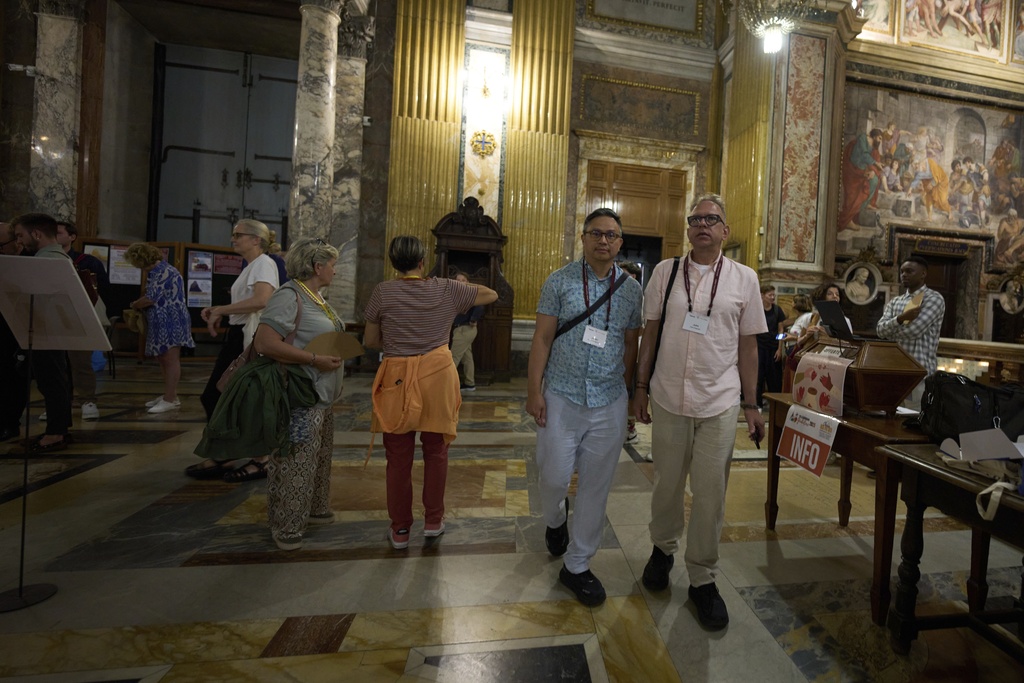 Justin Del Rosario, left, and John Capozzi arrive to attend attend a vigil prayer for members of the LGBTQ+ community in the Church of the Gesu' in central Rome, Friday, Sept. 5, 2025. (AP Photo/Andrew Medichini)