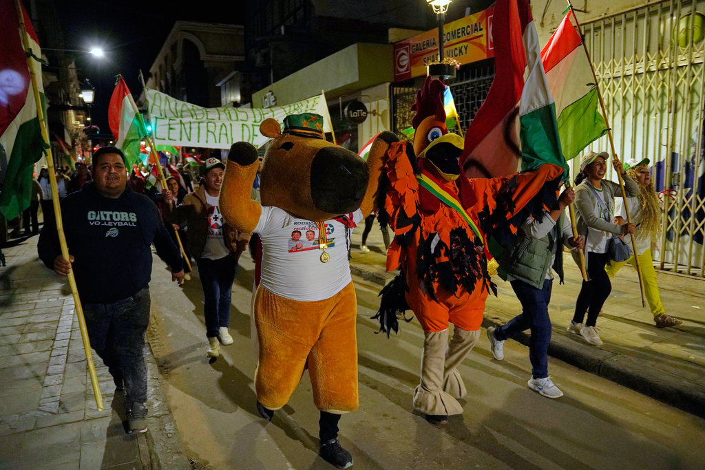 Suppoters of presidential candidate Rodrigo Paz celebrate after early results showed him leading in the presidential runoff election in Tarija, Bolivia, Sunday, Oct. 19, 2025. (AP Photo/Freddy Barragan)