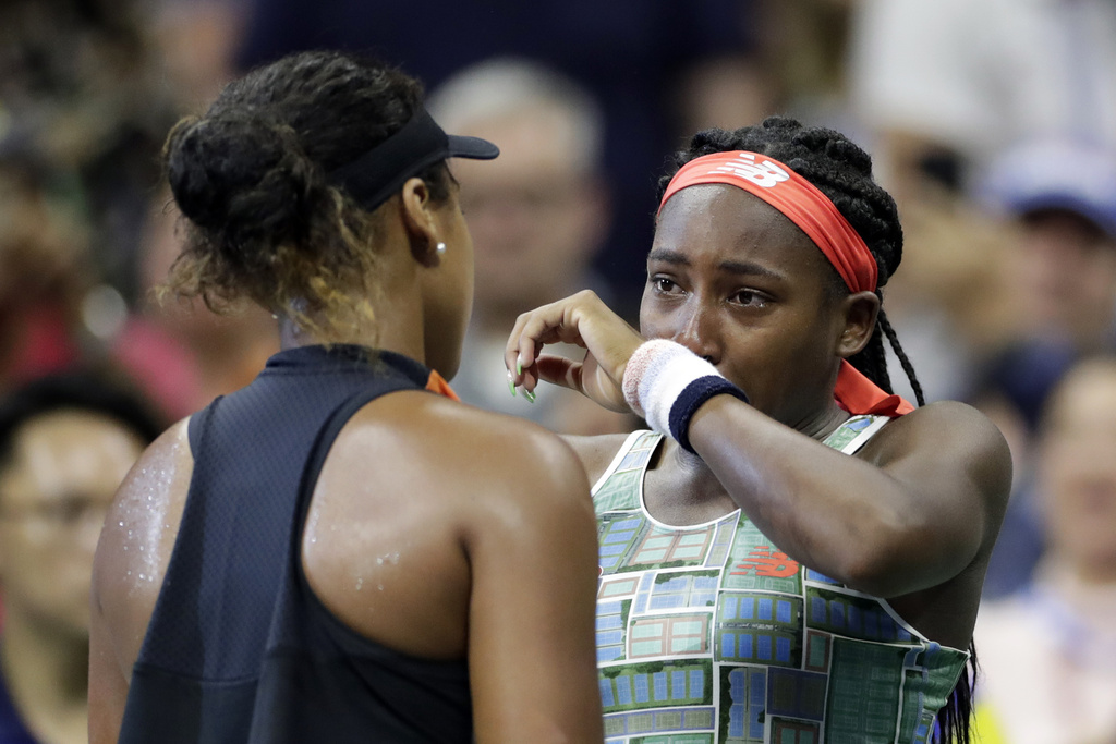 FILE - Coco Gauff, right, of the United States, wipes away tears while talking to Naomi Osaka, of Japan, after Osaka defeated Gauff in the third round of the U.S. Open tennis tournament Saturday, Aug. 31, 2019, in New York. (AP Photo/Adam Hunger, File)