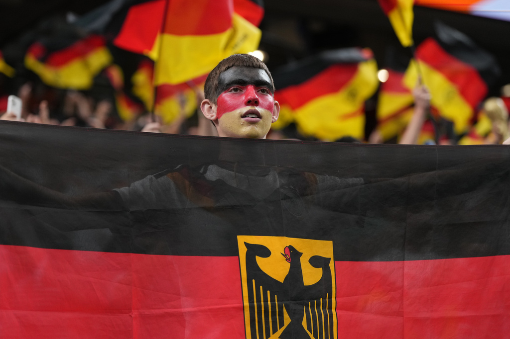 A German fan holds national flag before the World Cup Group E soccer match between Germany and Curacao in Houston, Sunday, June 14, 2026. (AP Photo/Eric Gay)