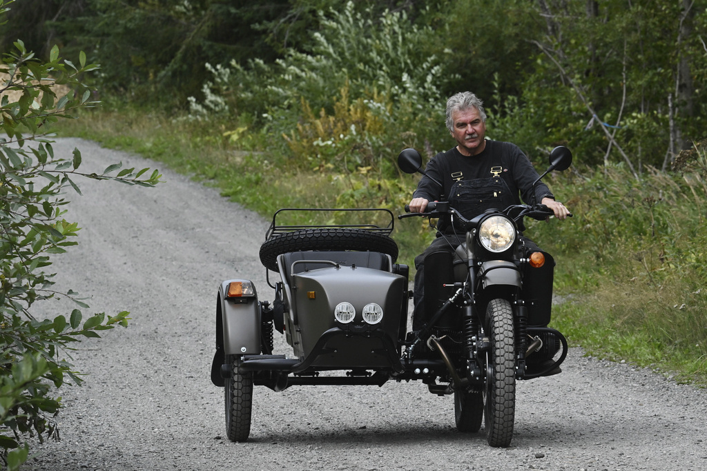 Alaska resident Mark Warren rides the a new Ural motorcycle he received as a gift from the Russian government in Anchorage, Alaska, Monday, Aug. 18, 2025, after Russian President Vladimir Putin's visit to the state for a summit meeting with U.S. President Trump. (Bill Roth/Anchorage Daily News via AP)