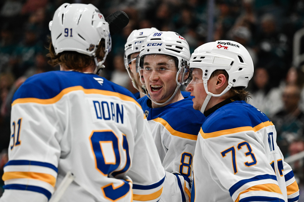 Buffalo Sabres center Noah Ostlund (86), center, reacts after scoring a goal against the San Jose Sharks during the second period of an NHL hockey game Thursday, March 19, 2026, in San Jose, Calif. (AP Photo/Thien-An Truong)