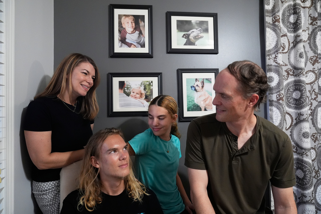 Meaghan and Chris Marr prepare to pose for a photograph with their children on Thursday, Sept. 25, 2025, in Cartersville, Ga. (AP Photo/Brynn Anderson)