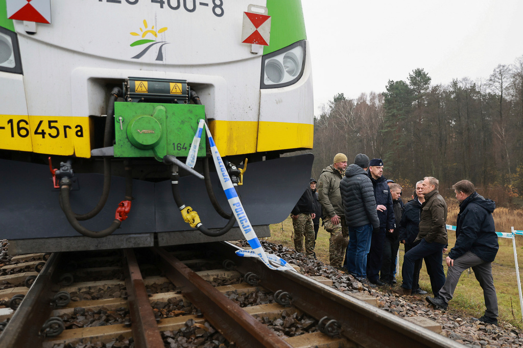 FILE - Polish Prime Minister Donald Tusk, second right, visits the sabotaged rail line near Mika, Poland, Nov. 17, 2025. (AP Photo/KPRM, File)