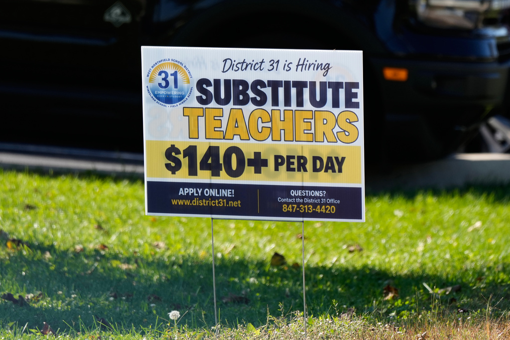 A hiring sign is displayed in Northbrook, Ill., Tuesday, Oct. 20, 2026. (AP Photo/Nam Y. Huh)