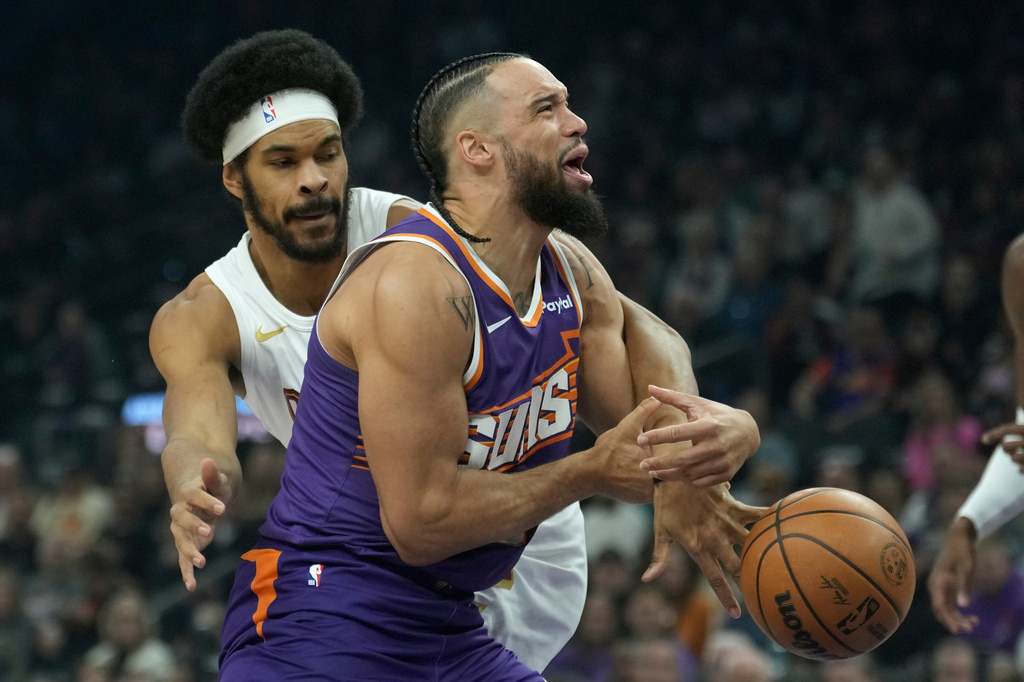 Phoenix Suns forward Dillon Brooks, right, is fouled by Cleveland Cavaliers center Jarrett Allen during the first half of an NBA basketball game Friday, Jan. 30, 2026, in Phoenix. (AP Photo/Ross D. Franklin)