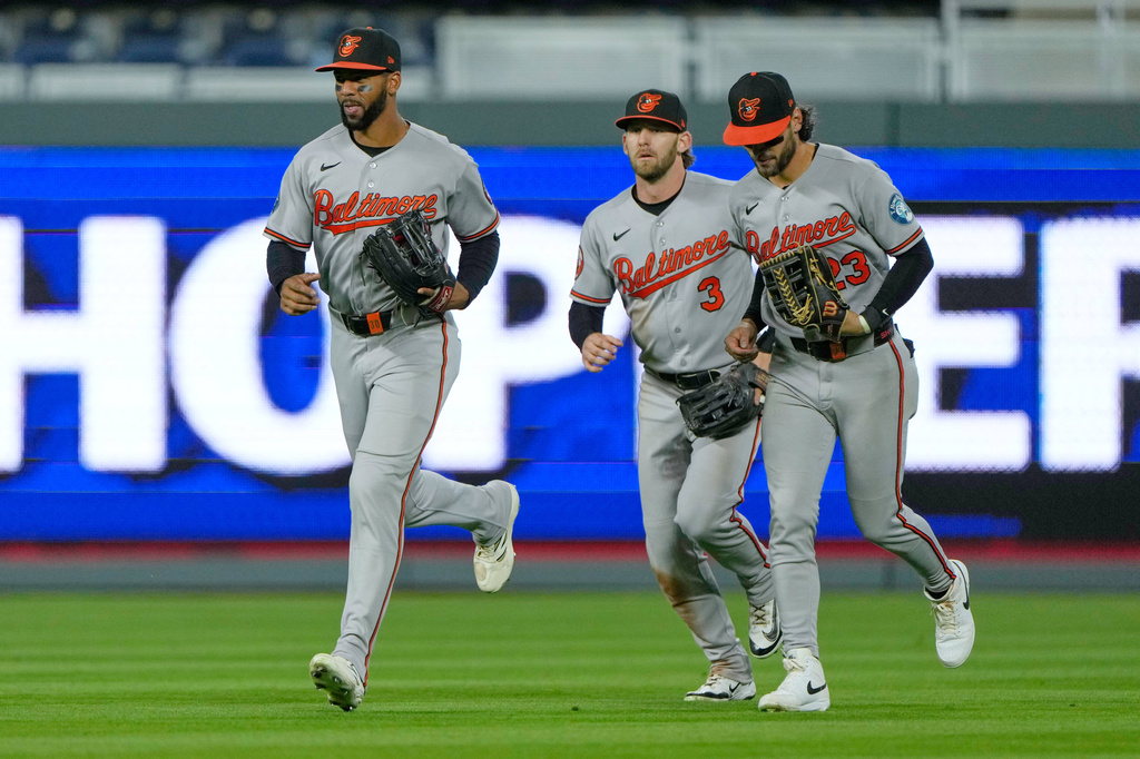 Baltimore Orioles outfielders Leody Taveras, left, Taylor Ward (3) and Blaze Alexander, right, run off the field after their baseball game against the Kansas City Royals, Monday, April 20, 2026, in Kansas City, Mo. (AP Photo/Charlie Riedel)