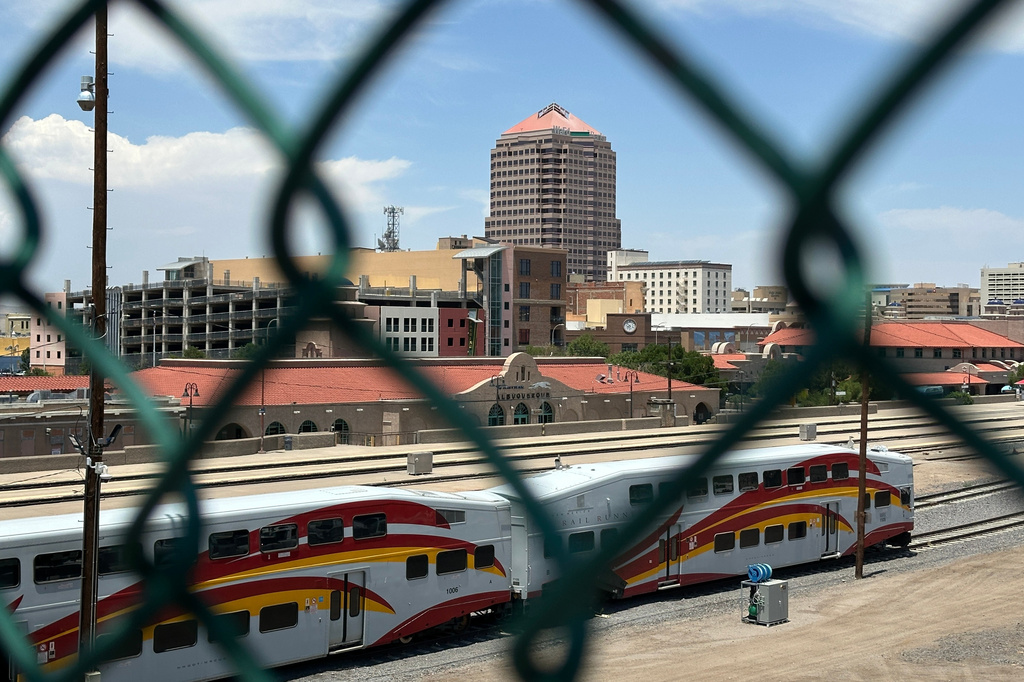 The tallest building in downtown Albuquerque, N.M., which houses the U.S. attorney's office, is seen beyond a chain link fence on Friday, June 12, 2026. (AP Photo/Susan Montoya Bryan)