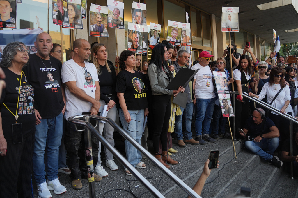 Einav Zangauker, center right, mother of Matan Zangauker, who was kidnapped by Hamas, speaks during a rally at a plaza known as hostages square, in Tel Aviv, Israel, Saturday, Oct. 11, 2025, ahead of the expected release of the hostages held in the Gaza Strip. (AP Photo/Francisco Seco)
