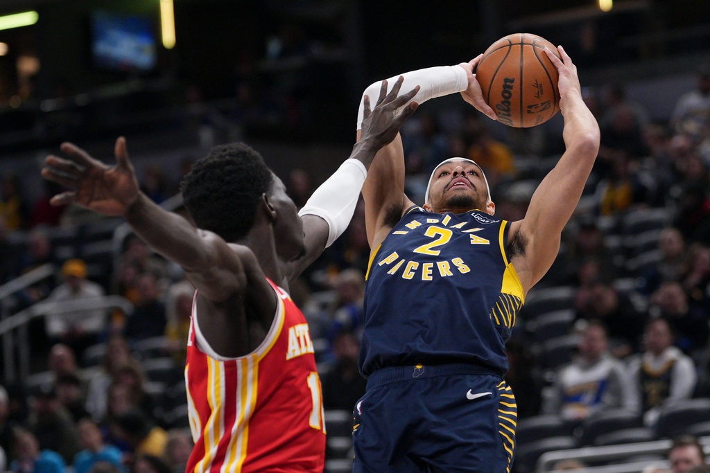Indiana Pacers guard Andrew Nembhard, right, shoots over Atlanta Hawks forward Mouhamed Gueye during the first half of an NBA basketball game in Indianapolis, Saturday, Jan. 31, 2026. (AP Photo/AJ Mast)