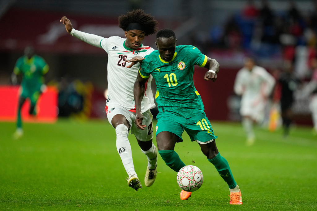 Sudan's Sheddy Ezeldin, left, and Senegal's Sadio Mane fight for the ball during the Africa Cup of Nations best of 16 soccer match between Senegal and Sudan in Tangier, Morocco, Saturday, Jan. 3, 2026. (AP Photo/Mosa'ab Elshamy)