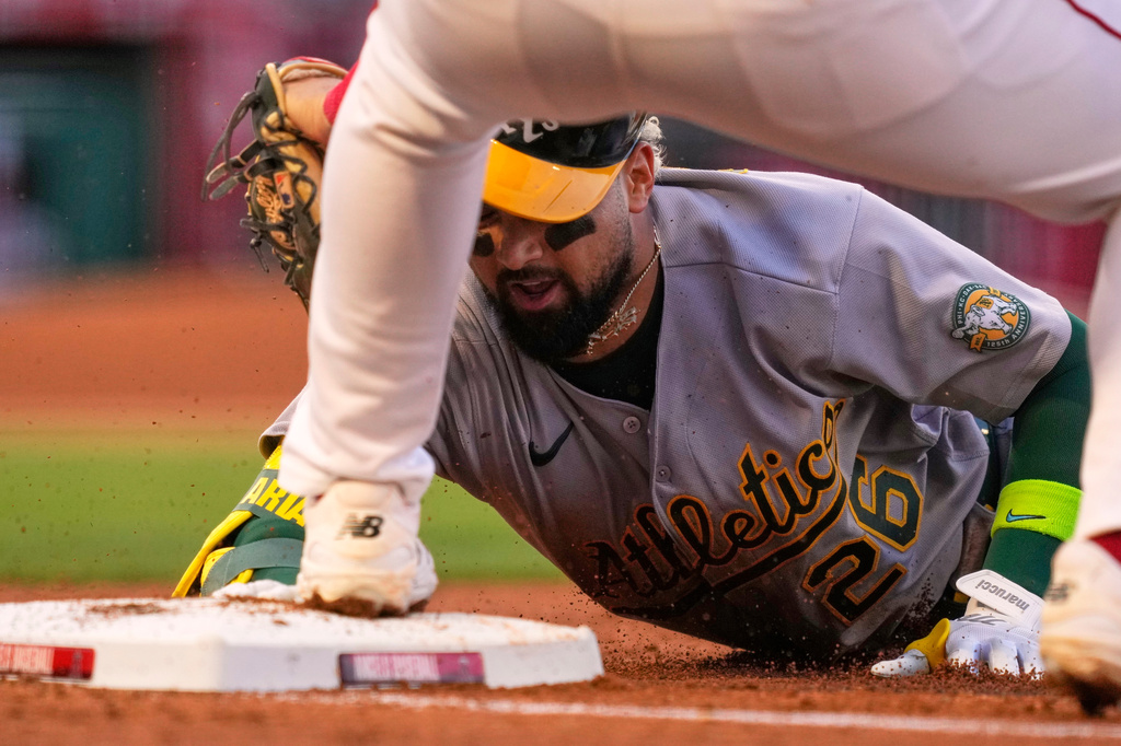 Athletics' Carlos Cortes, right, is tagged out at first by Los Angeles Angels first baseman Nolan Schanuel after trying to stretch a single during the fourth inning of a baseball game Thursday, May 21, 2026, in Anaheim, Calif. (AP Photo/Mark J. Terrill)