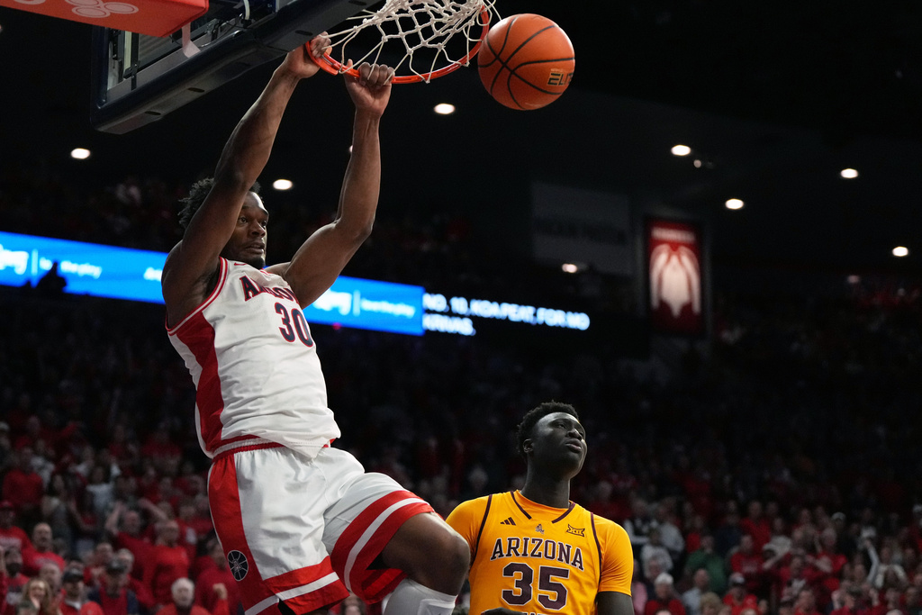 Arizona forward Tobe Awaka dunks over Arizona State center Massamba Diop (35) during the second half of an NCAA college basketball game, Wednesday, Jan. 14, 2026, in Tucson, Ariz. (AP Photo/Rick Scuteri)