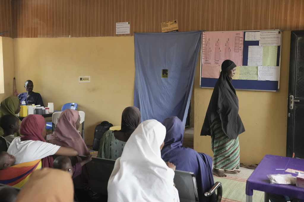 Falmata Muhammed, who once lost her pregnancy, leaves after a checkup at a facility run by aid group International Rescue Committee, in Magumeri, in northeast Nigeria's Borno state, Tuesday, July 22, 2025. (AP Photo/Sunday Alamba)