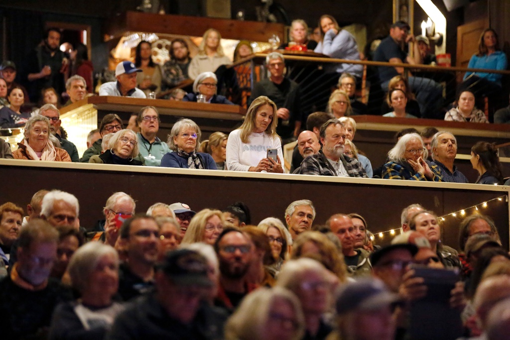 A crowd watches as Democratic Maine Senate candidate Graham Platner speaks at a town hall in Ogunquit, Maine, Wednesday, Oct. 22, 2025. (AP Photo/Caleb Jones)