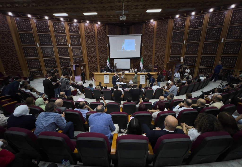 Syrian electoral college members and candidates attend the ballots' count shortly after polling stations closed at Latakia's Governor building, in the coastal city of Latakia, Syria, Sunday, Oct. 5, 2025. (AP Photo/Hussein Malla)