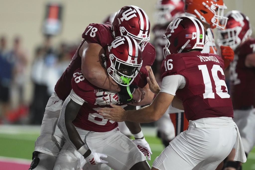 Indiana running back Khobie Martin (28) celebrates a touchdown run with offensive lineman Pat Coogan (78) and quarterback Alberto Mendoza during the second half of an NCAA college football game, Saturday, Sept. 20, 2025, in Bloomington, Ind. (AP Photo/Darron Cummings)