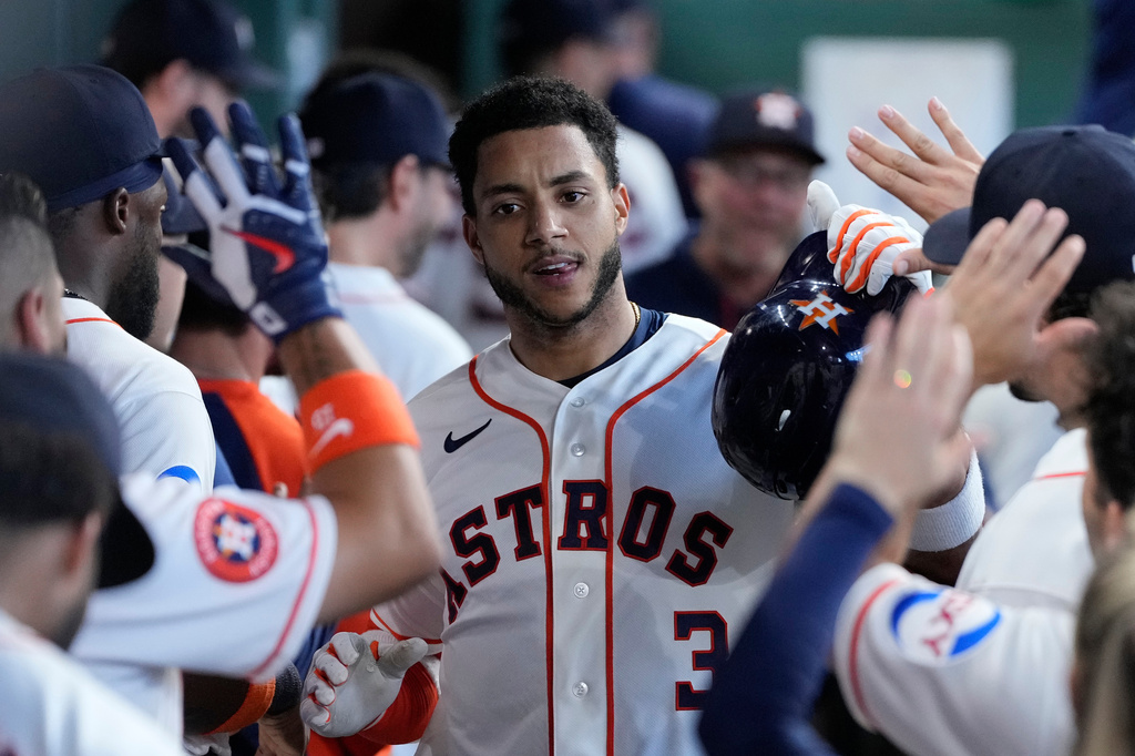 Houston Astros' Jeremy Peña is congratulated in the dugout after hitting a solo home run during the third inning of a baseball game against the Detroit Tigers, Wednesday, June 17, 2026, in Houston. (AP Photo/Kevin M. Cox)
