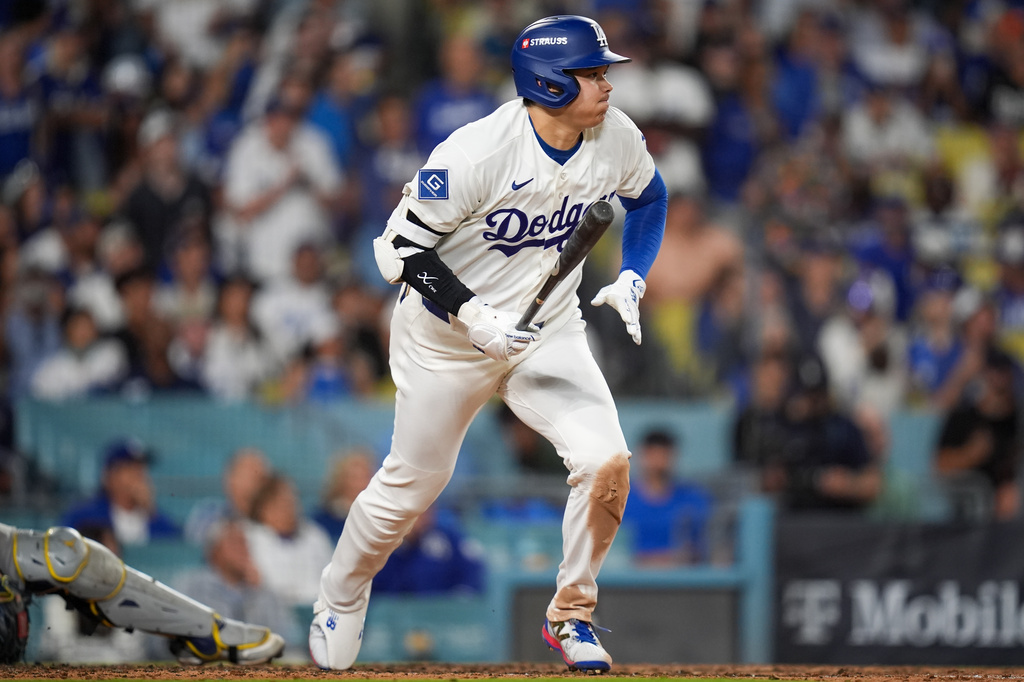 Los Angeles Dodgers designated hitter Shohei Ohtani (17) follows through on a base hit during the eighth inning of Game 3 of baseball's National League Championship Series between the Milwaukee Brewers and the Los Angeles Dodgers, Wednesday, Oct. 14, 2026, in Los Angeles. (AP Photo/Gregory Bull)