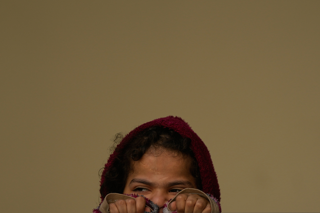 A girl displaced by Israeli airstrikes, looks on at a school used as a shelter in Beirut, Lebanon, Monday, March 9, 2026. (AP Photo/Hassan Ammar)