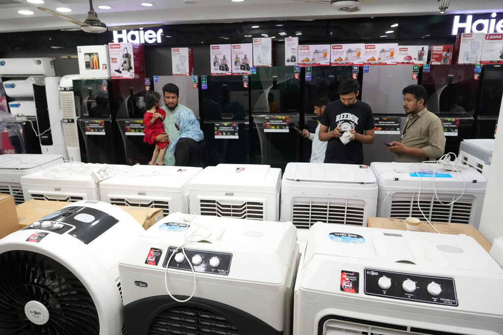 People visit a store to buy room air cooler, in Lahore, Pakistan, Friday, June 12, 2026. (AP Photo/K.M. Chaudary)