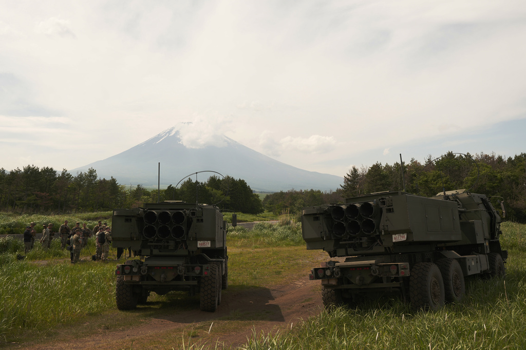 U.S. forces members answer to media members' questions during a media tour for a live-fire training of the High Mobility Artillery Rocket System, short for HIMARS, at Camp Fuji, in Gotemba, southwest of Tokyo, Wednesday, May 20, 2026, as Mount Fuji, back, is seen. (AP Photo/Hiro Komae)