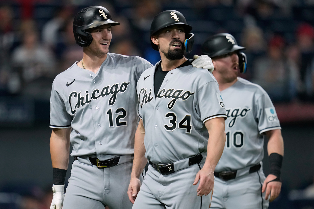 Chicago White Sox's Colson Montgomery (12), Randal Grichuk (34) and Chase Meidroth (10) walk back to the dugout after Montgomery and Meidroth scored and Gricjhuk was tagged out at home on a double hit by Kyle Teel in the sixth inning of a baseball game in Cleveland, Monday, Sept. 14, 2026. (AP Photo/Sue Ogrocki)