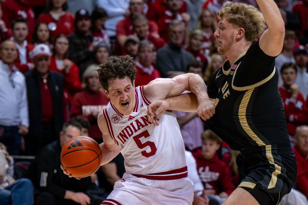 Indiana guard Conor Enright (5) makes contact with Purdue guard Jack Benter as he makes a move along the baseline during the second half of an NCAA college basketball game, Tuesday, Jan. 27, 2026, in Bloomington, Ind. (AP Photo/Doug McSchooler)