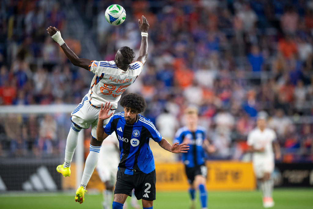 FC Cincinnati forward Kei Kamara (85) heads a ball as he is defended by CF Montréal defender Jalen Neal (2) during the first half of an MLS soccer match, Saturday, Oct. 18, 2025, in Cincinnati. (AP Photo/Tanner Pearson)