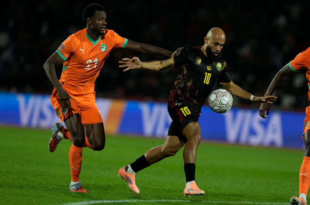 Cameroon's Bryan Mbeumo is challenged by Ivory Coast's Evan Ndicka during the Africa Cup of Nations group F soccer match between Ivory Coast and Cameroon, in Marrakech, Morocco, Sunday, Dec. 28, 2025. (AP Photo/Themba Hadebe)
