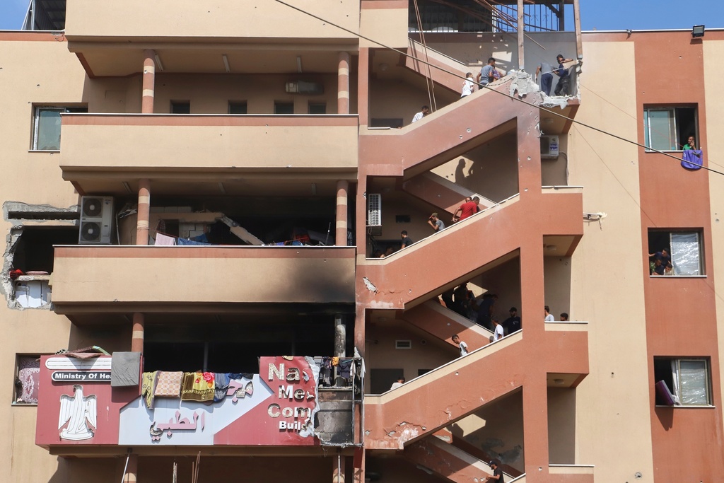 FILE - People walk up stairs to the site of an Israeli strike at Nasser Hospital, minutes before a second round of strikes hit the same spot in Khan Younis, Gaza Strip, Monday, Aug. 25, 2025. This was one of the last photos taken by journalist Mariam Dagga, who freelanced for The Associated Press and other outlets, before she walked to the site and was killed. (AP Photo/Mariam Dagga, File)