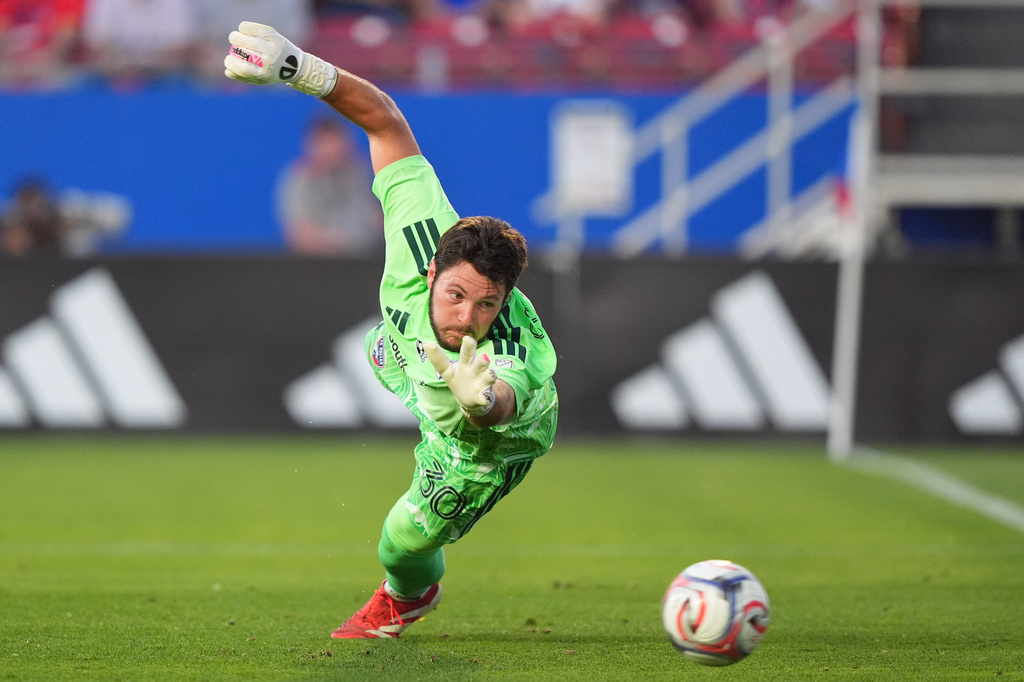 FC Dallas goalkeeper Michael Collodi reaches for a shot on goal during the first half of an MLS soccer match against the Vancouver Whitecaps FC in Frisco, Texas, Wednesday, May 13, 2026. (AP Photo/LM Otero)