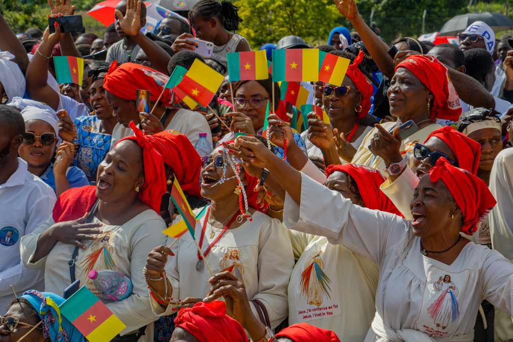 People cheer as Pope Leo XIV arrives in Yaounde, Cameroon, Wednesday, April 15, 2026. (AP Photo/Welba Yamo Pascal)