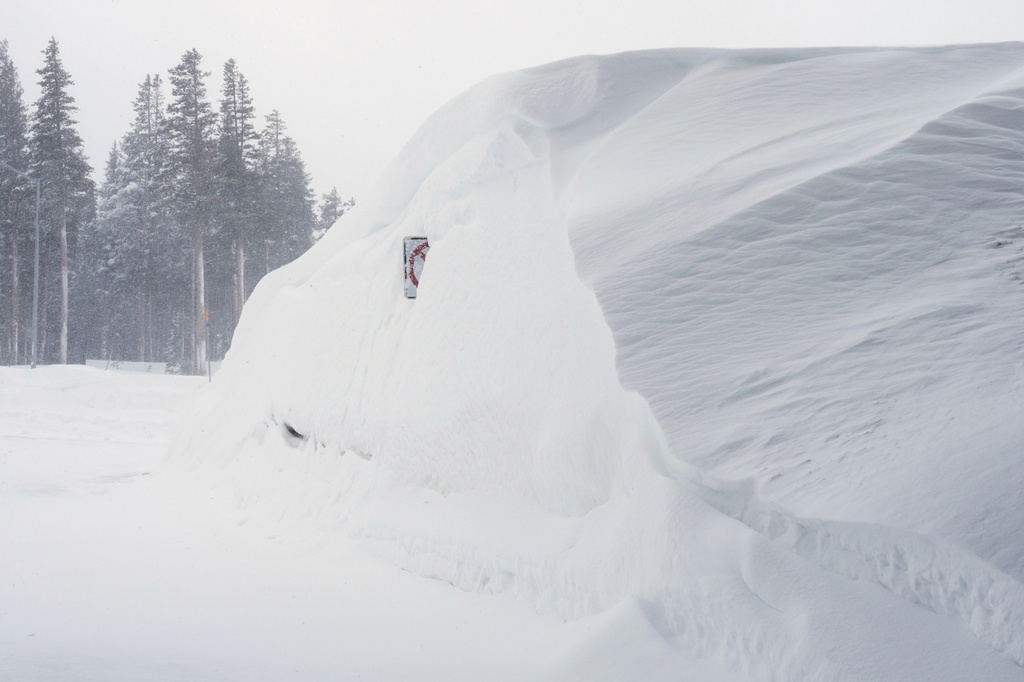 Snow piles up along a road on Wednesday, Feb. 18, 2026 near Soda Springs, Calif. (AP Photo/Brooke Hess-Homeier)